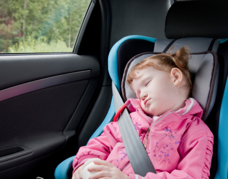 Girl sleeping in the car with seatbelt