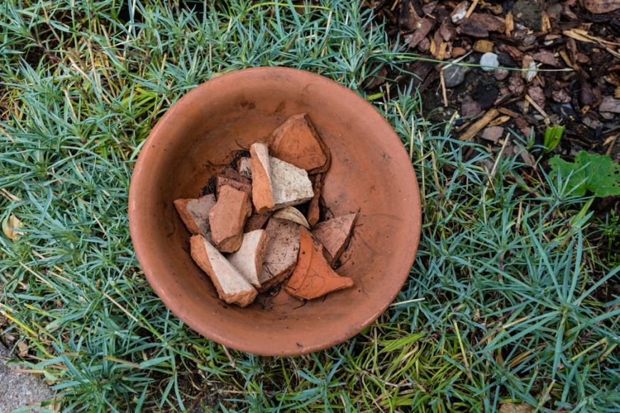 Use broken terracotta to line the base of pots Use broken terracotta to line the base of pots